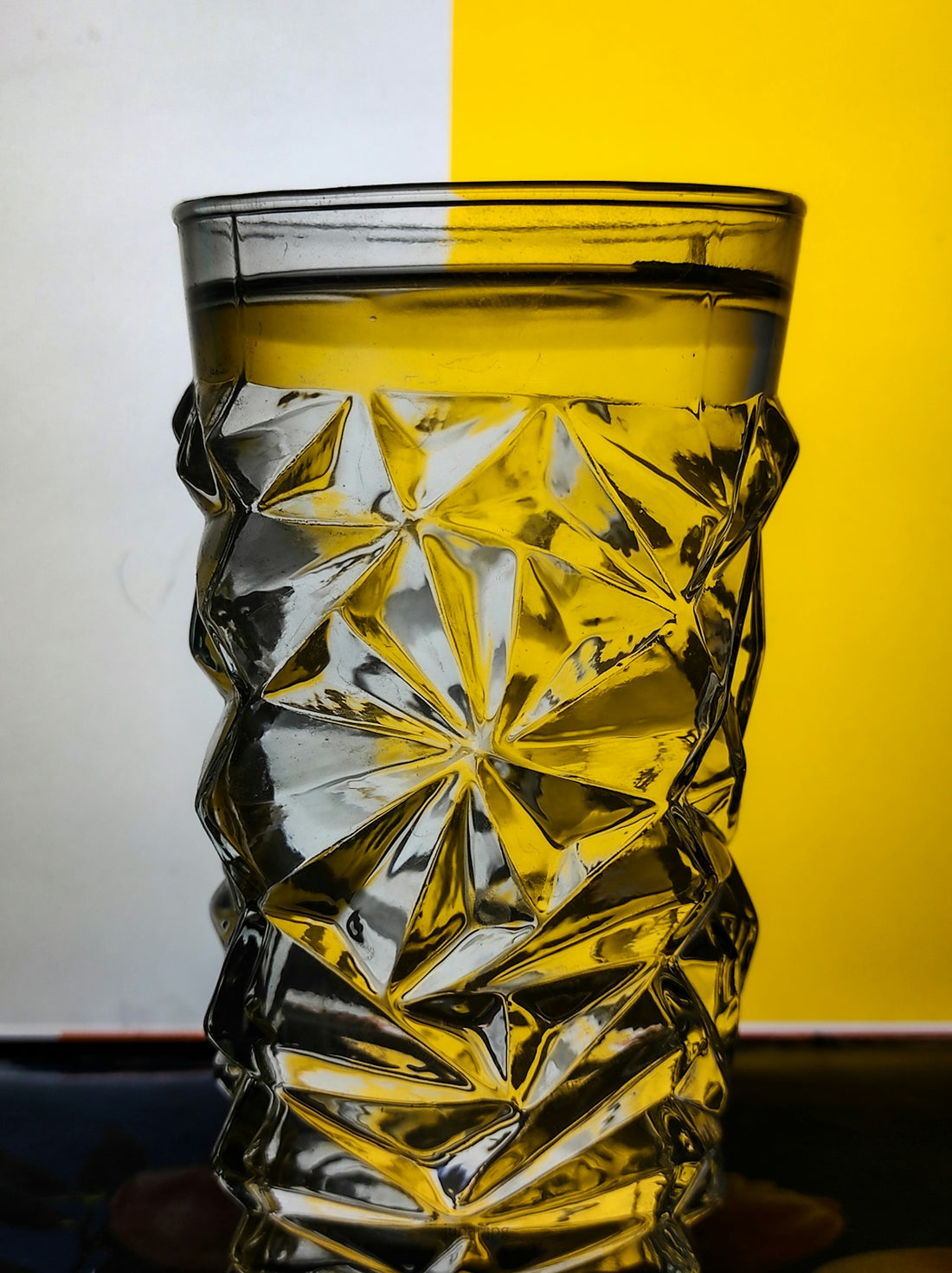 clear cut glass with yellow liquid