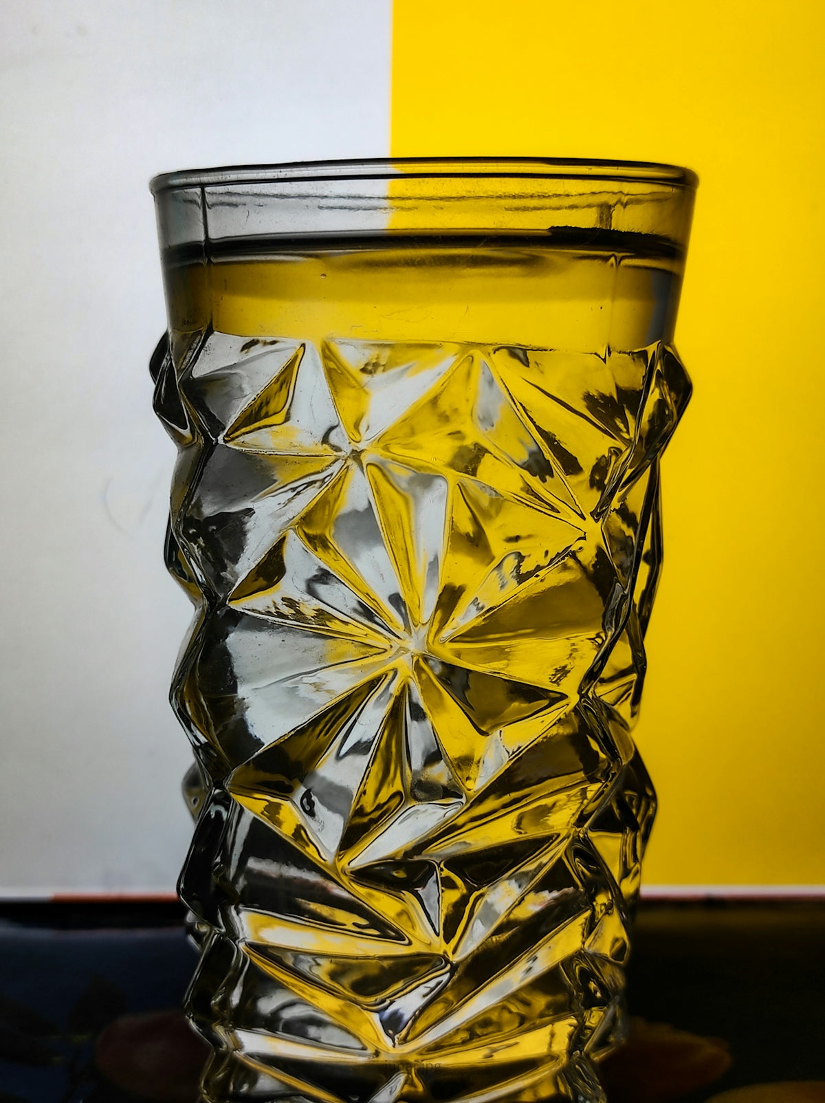 clear cut glass with yellow liquid