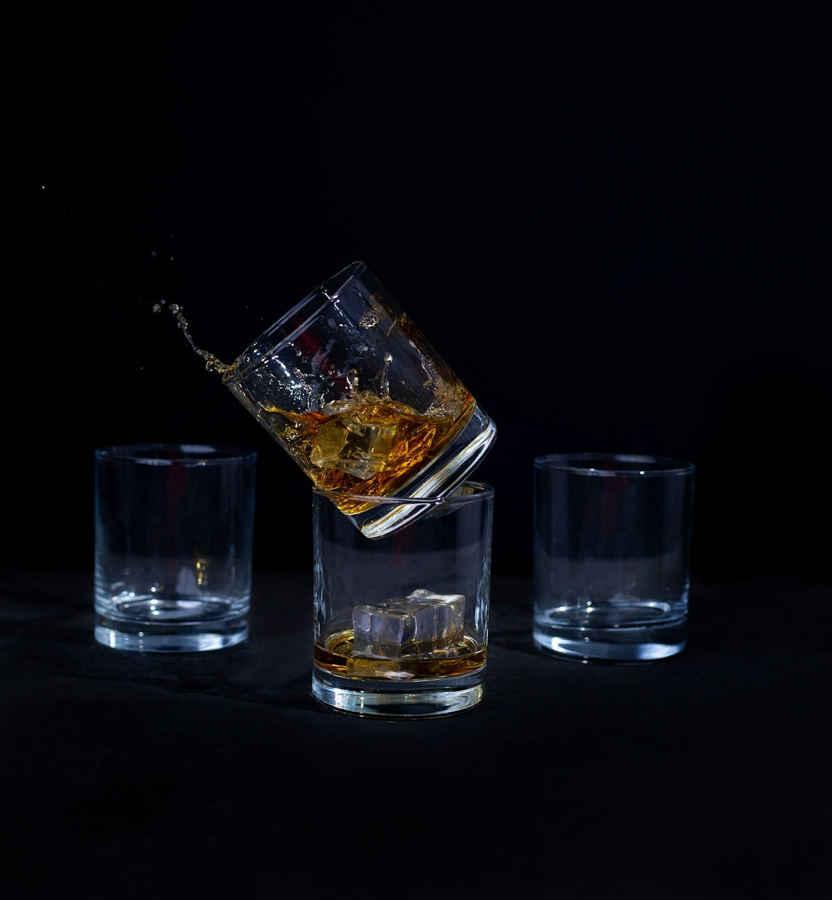 a glass of whiskey being poured into it