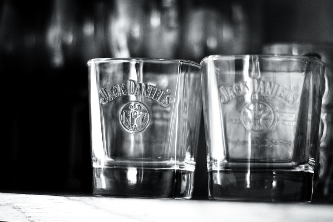 Three shot glasses sitting on top of a counter