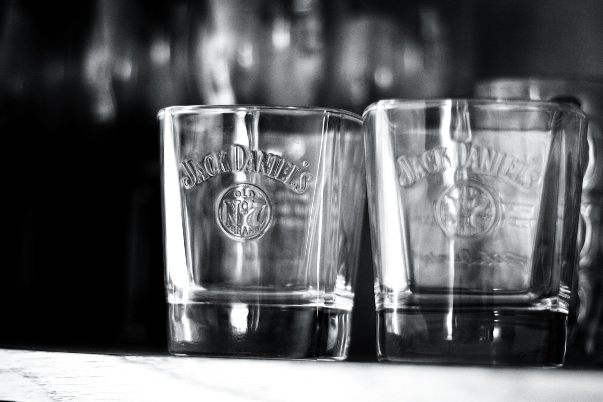 Three shot glasses sitting on top of a counter