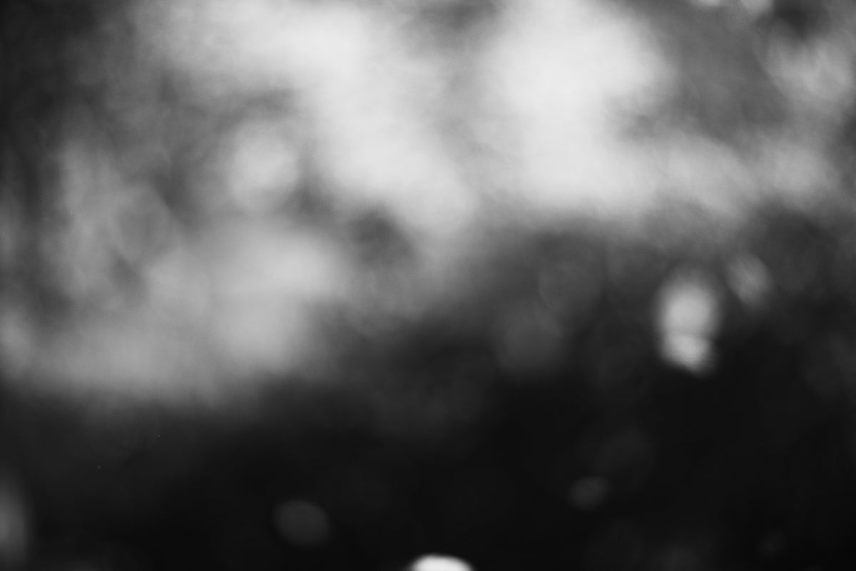 Out-of-focus, abstract black and white scene.