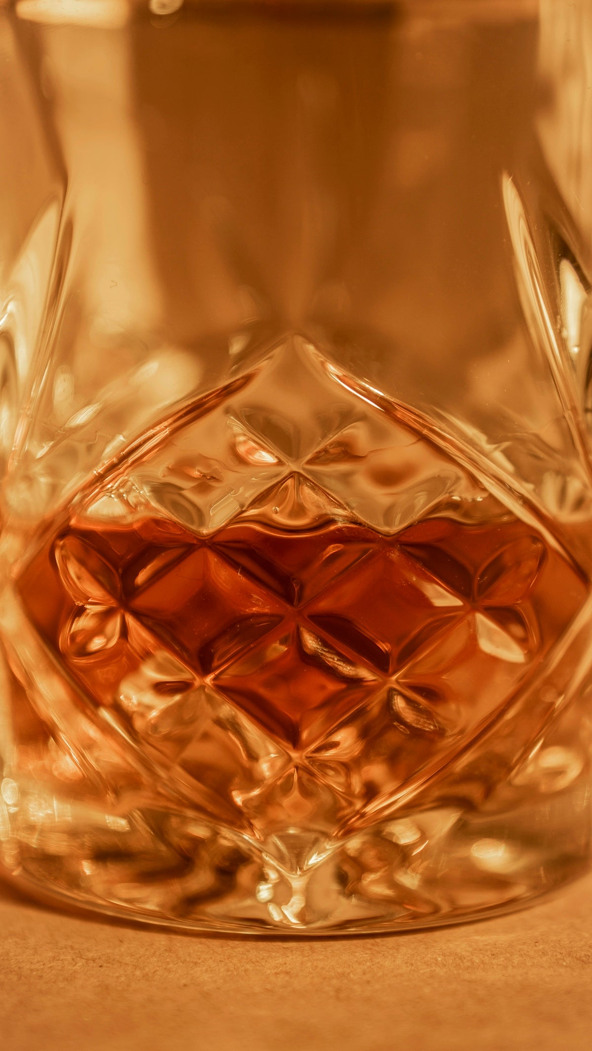 A glass of whiskey filled with amber liquid.