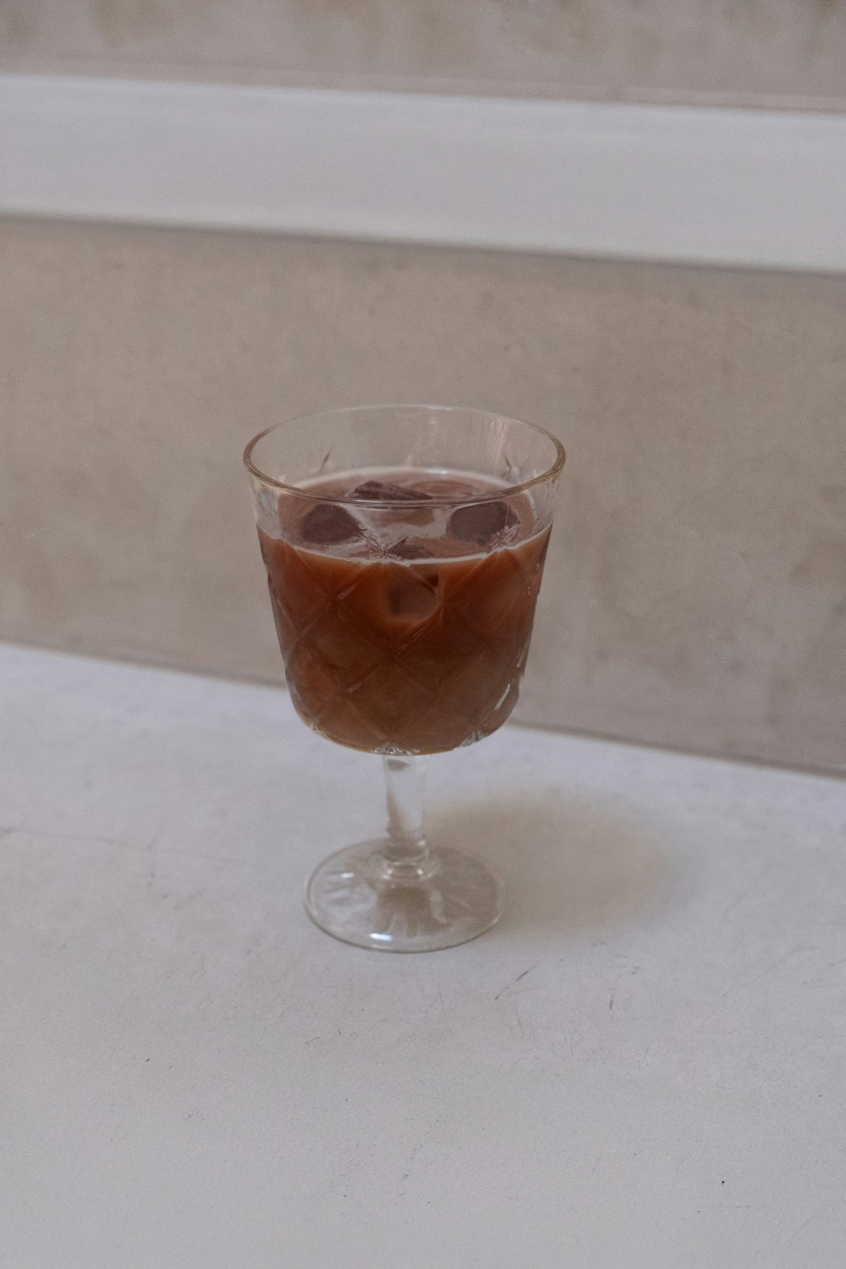 Iced coffee in a decorative glass.